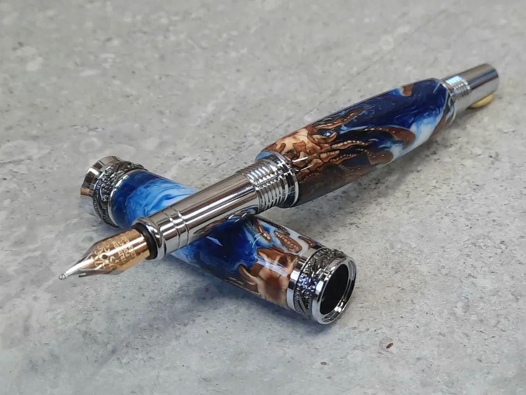 Fountain pen with pine cone.... and why I dont sell pens. The third pic shows a chunk missing that I didnt notice until I pressed in the end :( #fountainpen #blue #white #pinecone #jremperorfountainpen #screwup